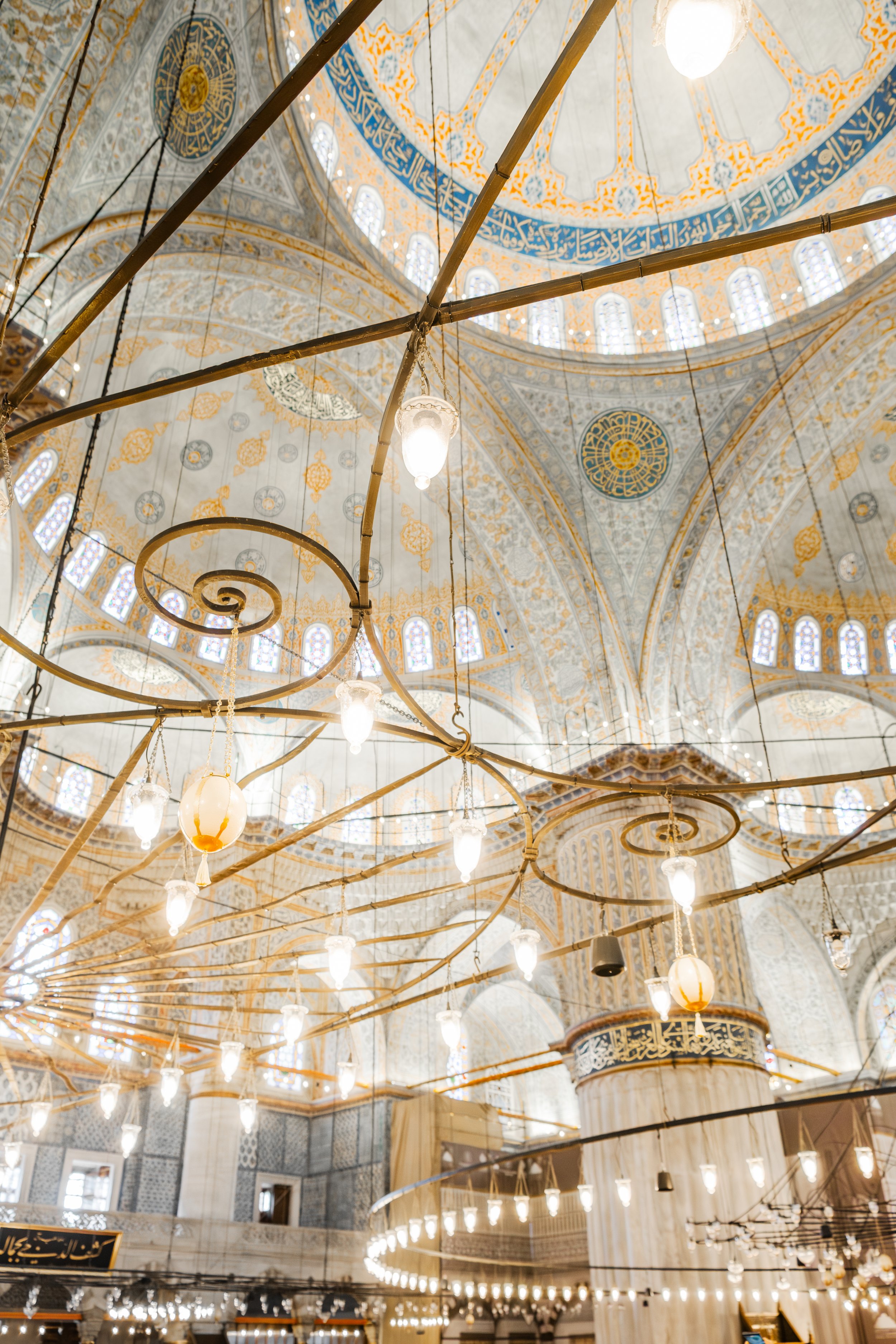 Interior dome with chandeliers and arches in the Blue Mosque in Istanbul.