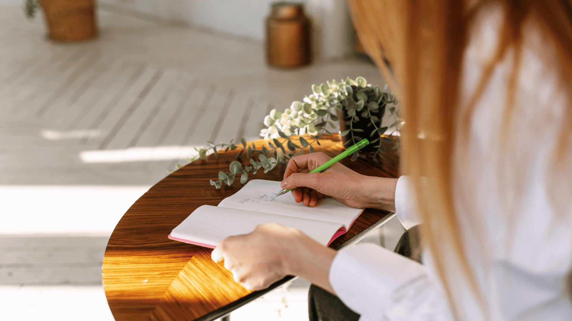 Therapist writing notes in a notebook, symbolizing the first steps of setting up a private practice in the Netherlands with clarity and organization.