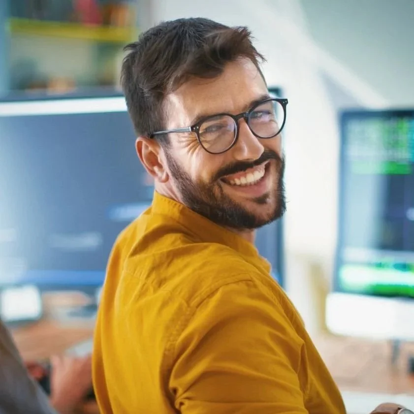 Confident male therapist working at his laptop, symbolizing a thriving and sustainable private practice supported by the Starter’s Kit in the Netherlands.
