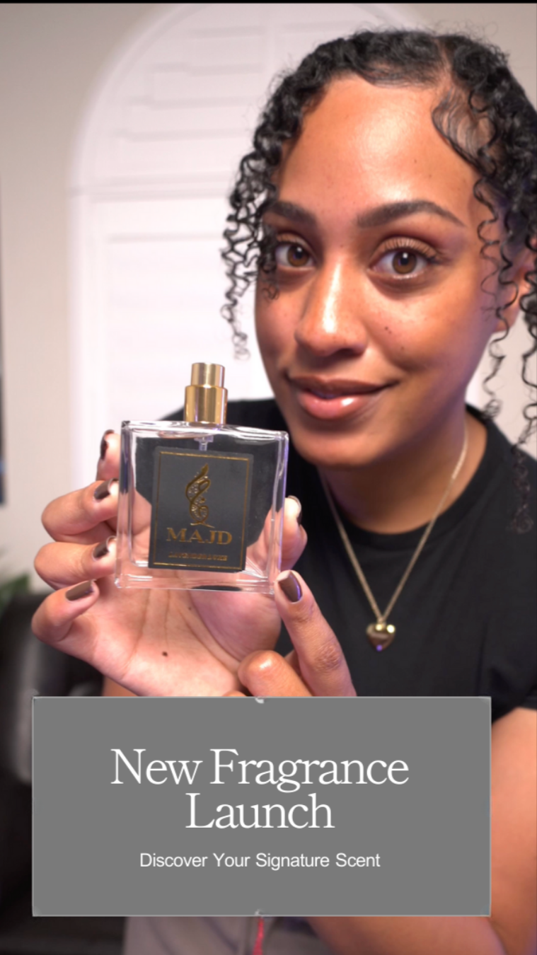 A woman with curly hair holds a perfume bottle labeled 'MAJD' and promotes a new fragrance launch with the tagline 'Discover Your Signature Scent'.