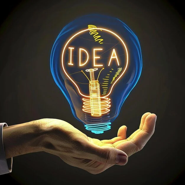 A human hand holding a glowing neon light bulb with the word "IDEA" inside it, symbolizing creativity and innovation.