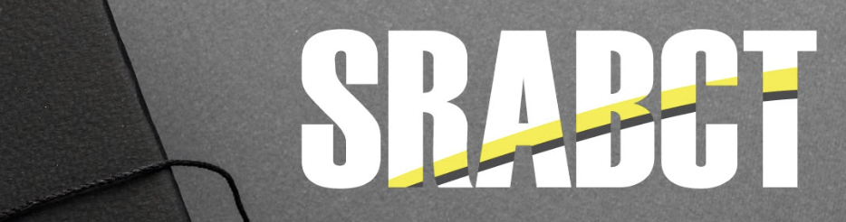 Close-up of a textured gray surface with bold white letters spelling 'SRABCT' and a yellow and black curved line crossing through the text.