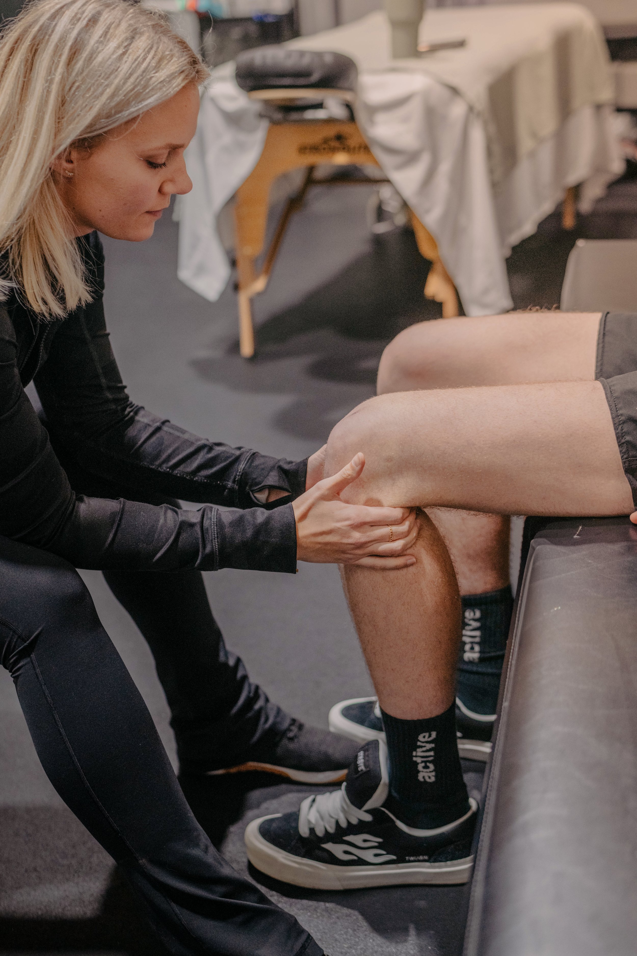 Dr. BettyLou DeYoung performing manual therapy on a patient's leg during a one-on-one physical therapy session in Temecula, CA