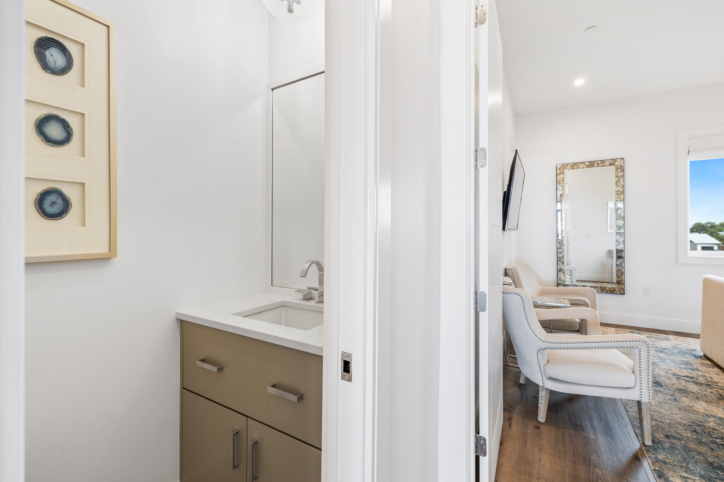 Half bath for guests adjacent to the kitchen and living room