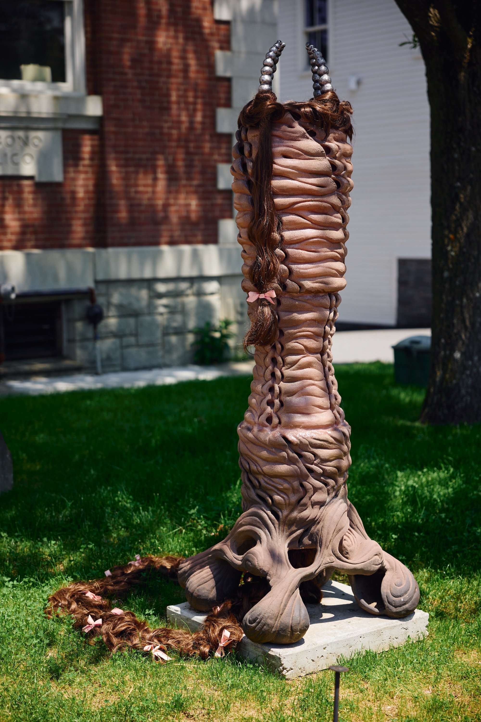 French Knitter (A Tube within a tube), 2025. Ceramic, cast aluminum, synthetic hair, silicone and latex ribbon. 79 x 28 x 24 in.
Photo: courtesy of The Current. 