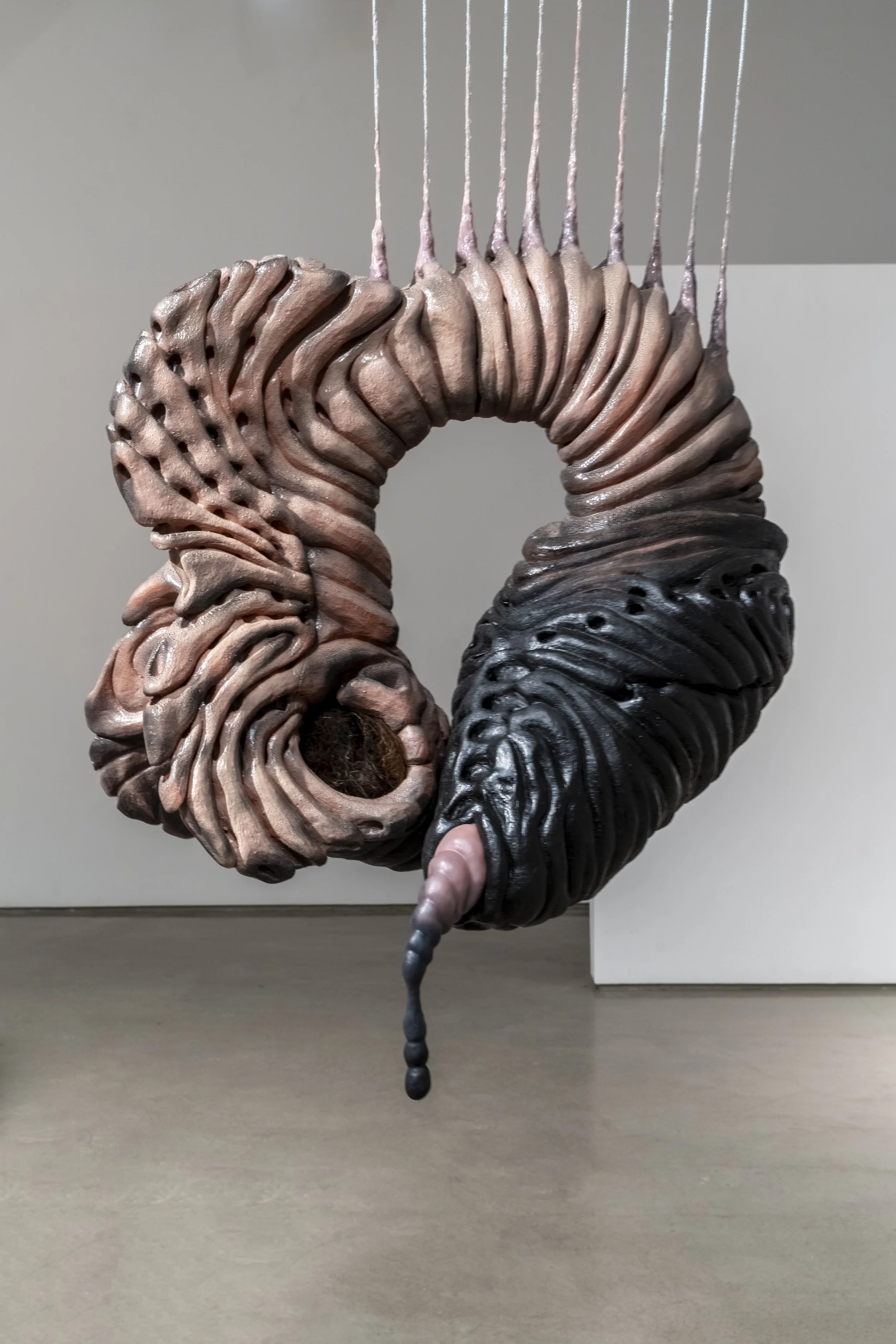 Coma, 2025. Ceramic, human hair, rubber, silicone. 31 x 32 x 23 in.
