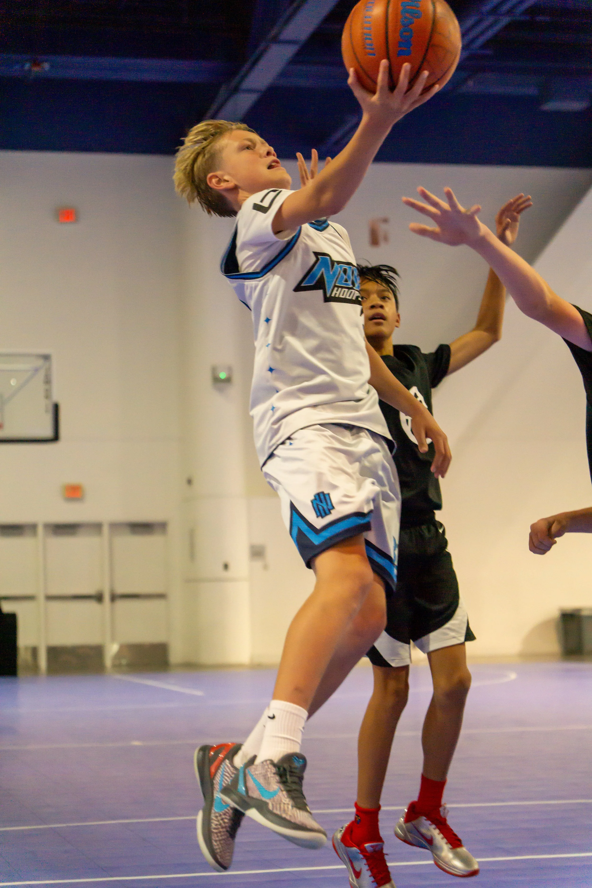 Nova Hoops middle school basketball player finishing at the basket