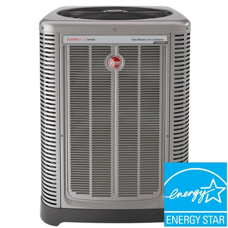 A gray Rheem Classic Plus high efficiency air conditioner unit with a vented front grill and a round top fan. There is an Energy Star logo in the bottom right corner.
