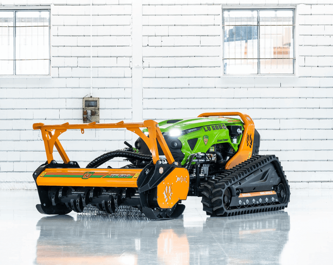 Green Climber LV600 remote-controlled tracked mower displayed on factory showroom floor