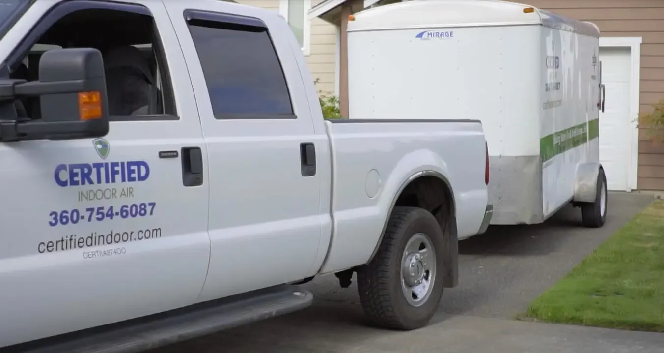 Certified Indoor Air truck with a trailer parked in a residential driveway.