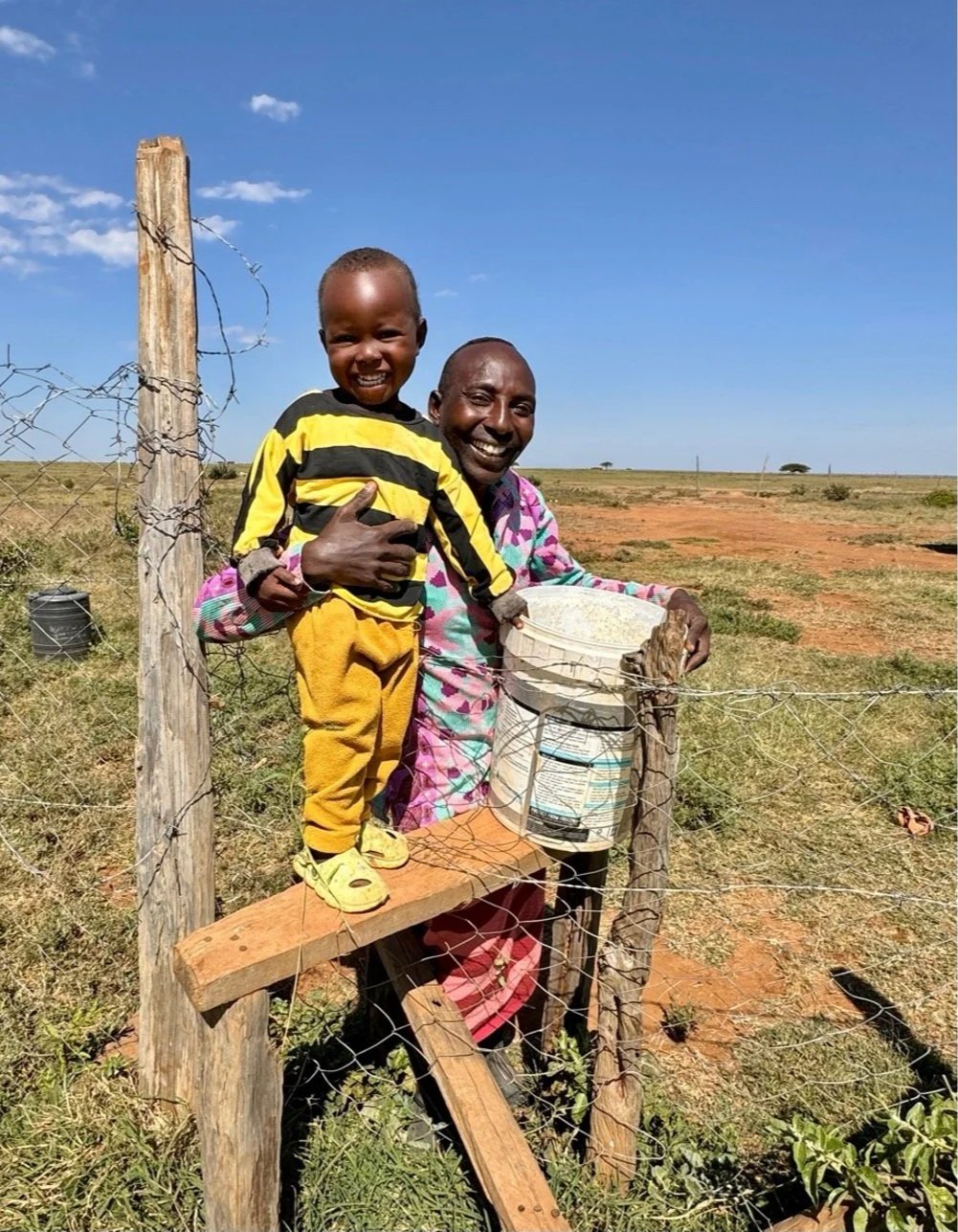 Musa & son (Kenya)
Samburu County, Kenya.  

Musa, one of the local employees of Sadhana Forest Kenya (SFK), has a thriving orchard of moringa trees. On this day, the work party was scheduled to help with the maintenance of his trees, and we were wel