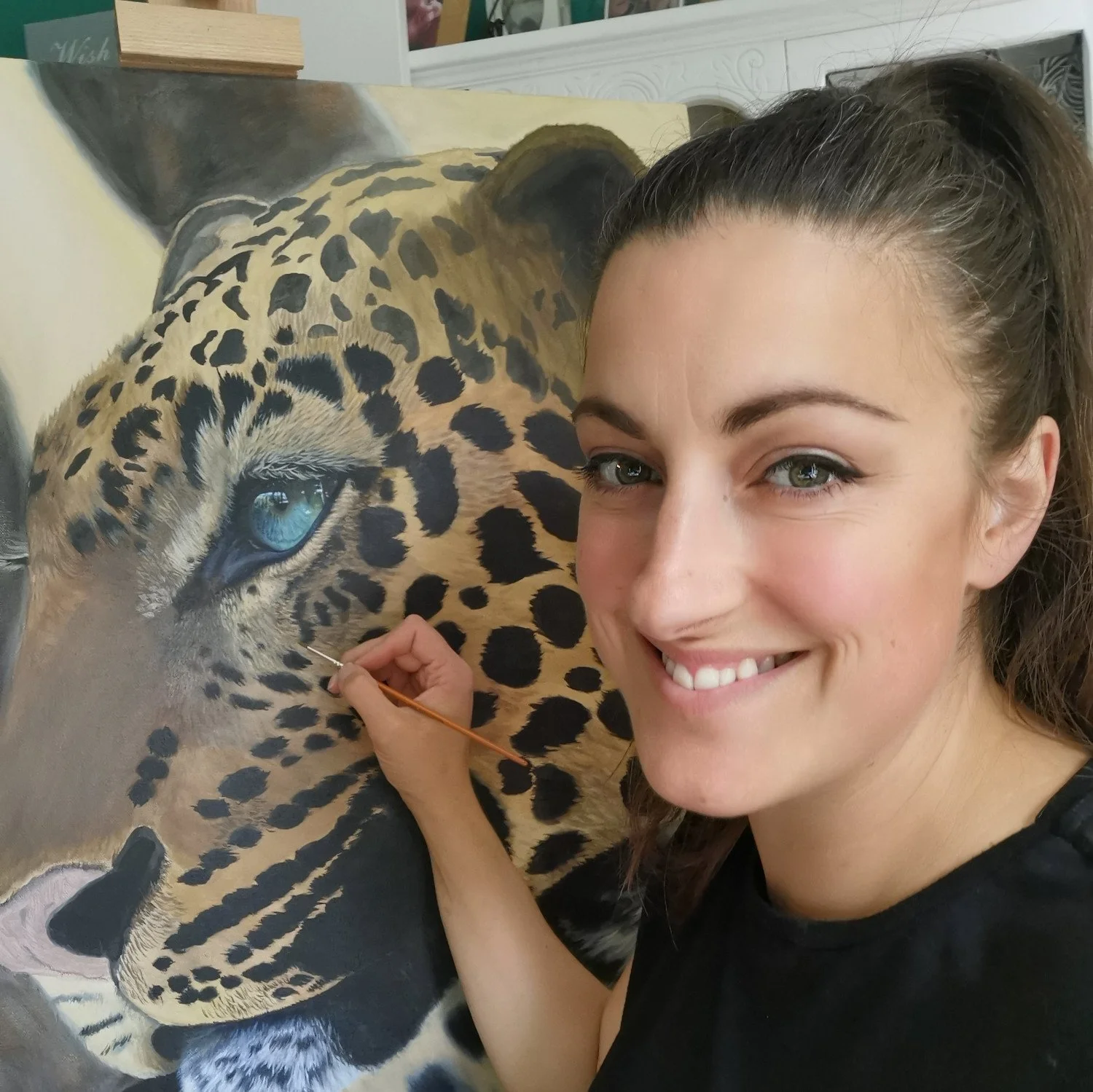 an artist painting a jaguar
