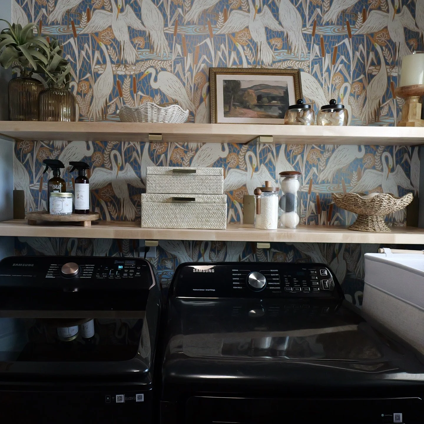This is your reminder that every space in your home matters✨

Even a laundry room can feel curated, layered, and full of personality. We traded blank walls for a statement backdrop and brought in warmth through wood tones, shelf styling, incorporated