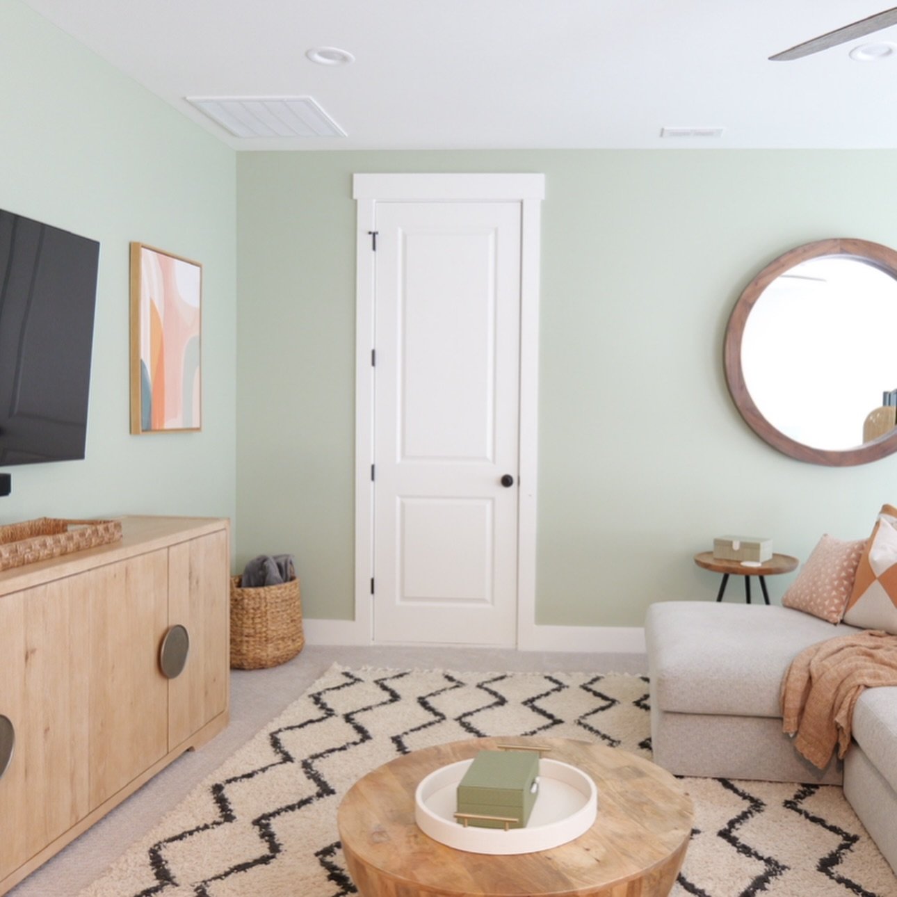 Talk about a happy place ☺️

This loft went from feeling oversized and unfinished to intentional with a fresh paint color, a rug, mirror, and wall art repurposed from another room, and thoughtfully sourced closed-storage furniture to keep the room fe