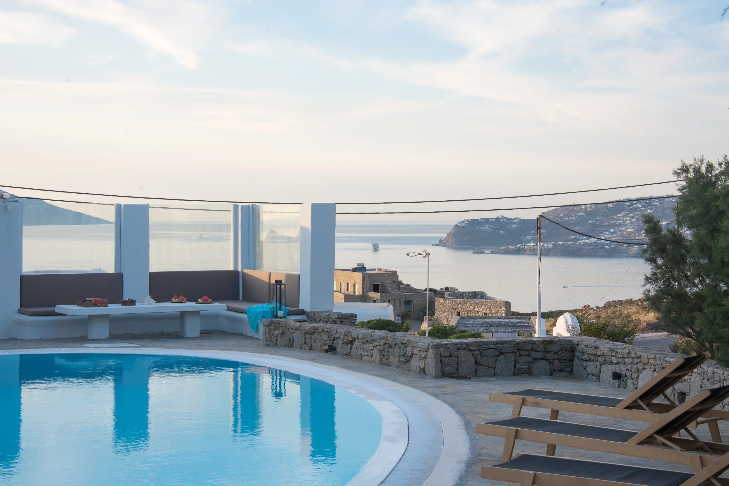 Private pool with lounge seating and panoramic Aegean Sea view, Villa Zanetti Mykonos.