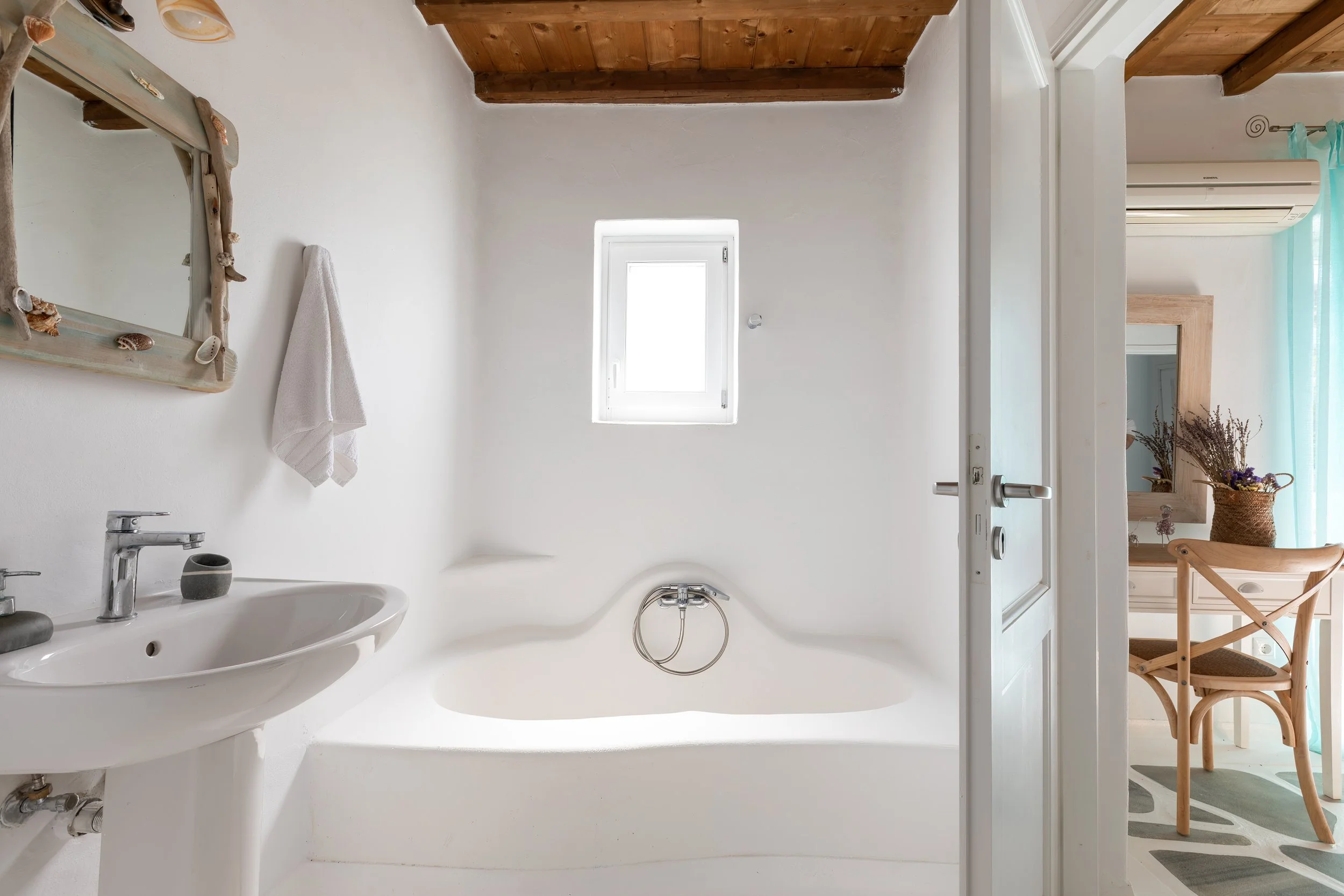 cycladic-bathroom-built-in-tub-doorway-to-bedroom-mykonos.jpg