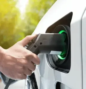 Person plugging an electric charger into a car.