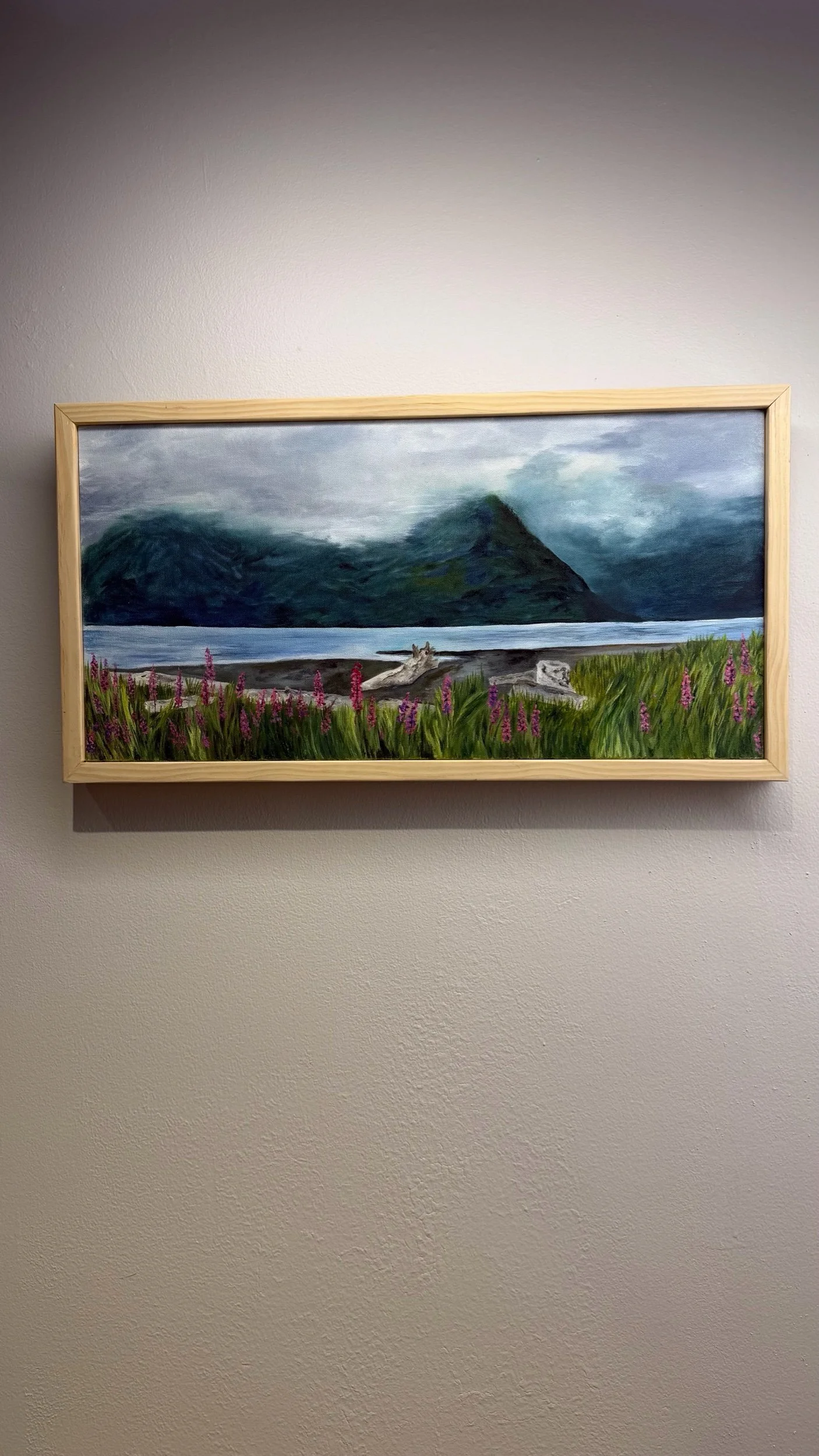 Original oil painting of fireweed and driftwood along Resurrection Bay beneath misty Alaska mountains, framed in natural pine.