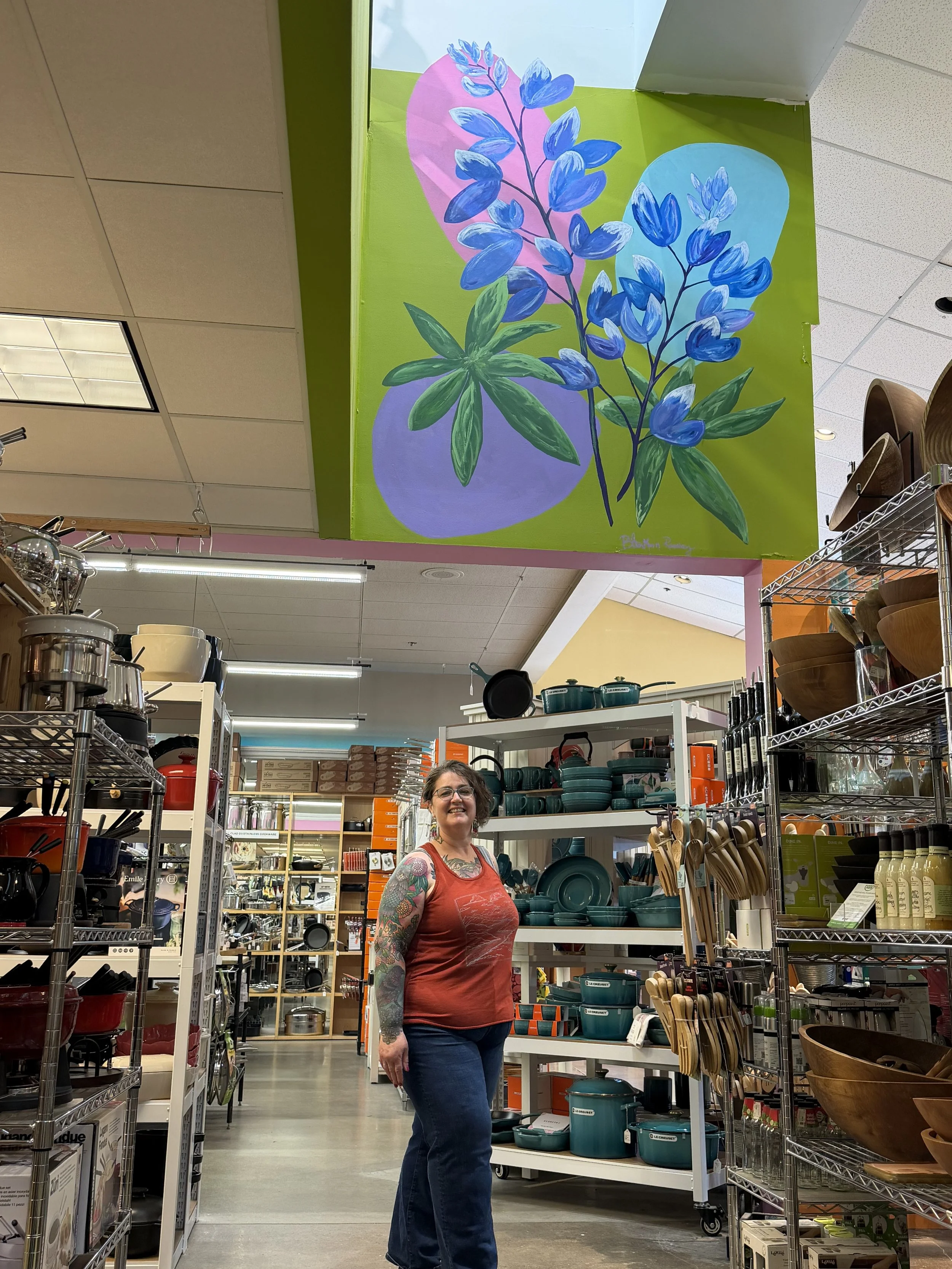 Large scale Lupine mural created for Metro Cooks - with me posing underneath