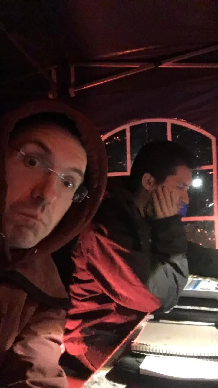 Dani Bartomeu and Gerard Pastor in a light programming session. Side selfie in a dark, cold setting.