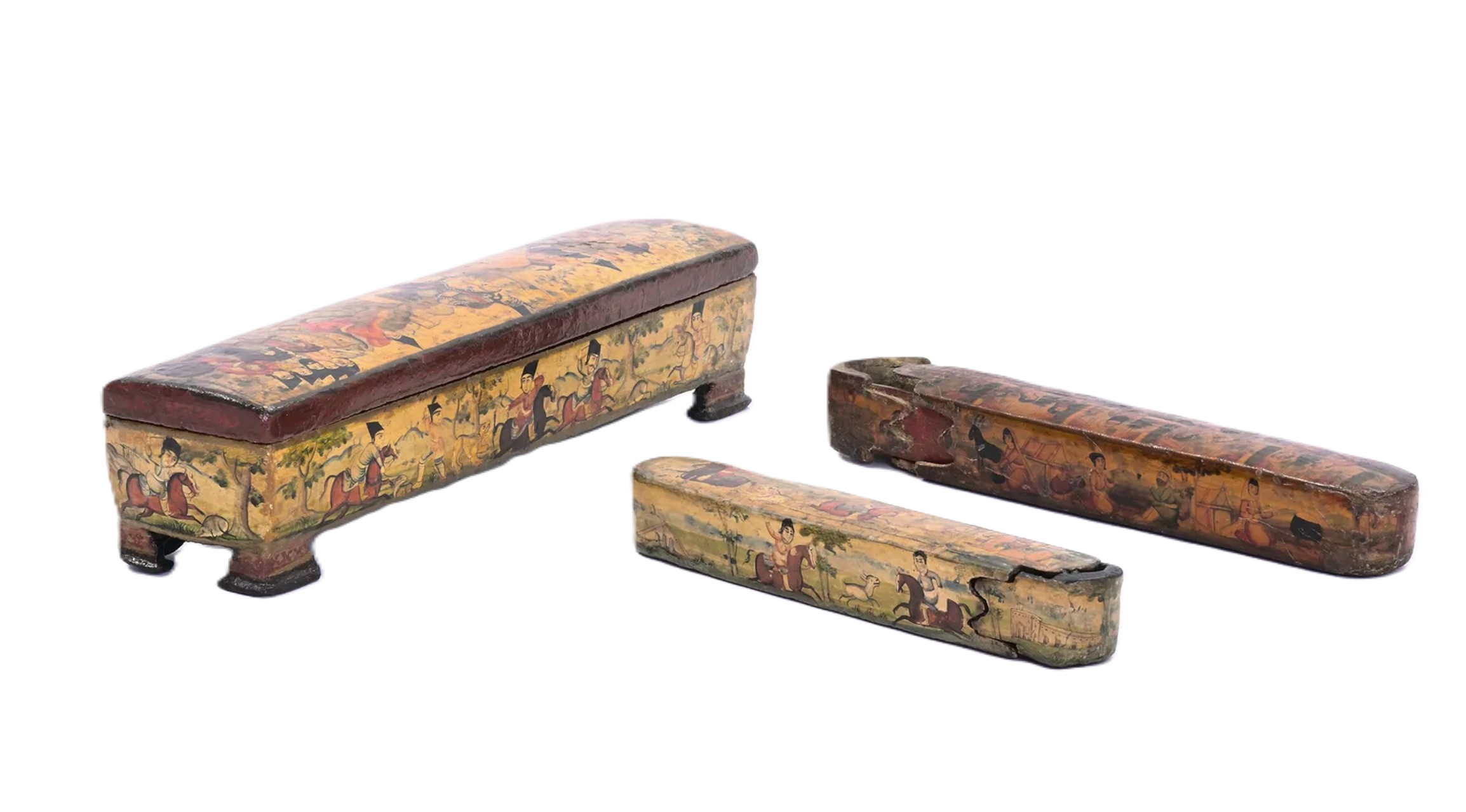 Three antique painted wooden boxes with lids, decorated with traditional Asian figures and scenes, arranged on a surface. The boxes show signs of wear and age.