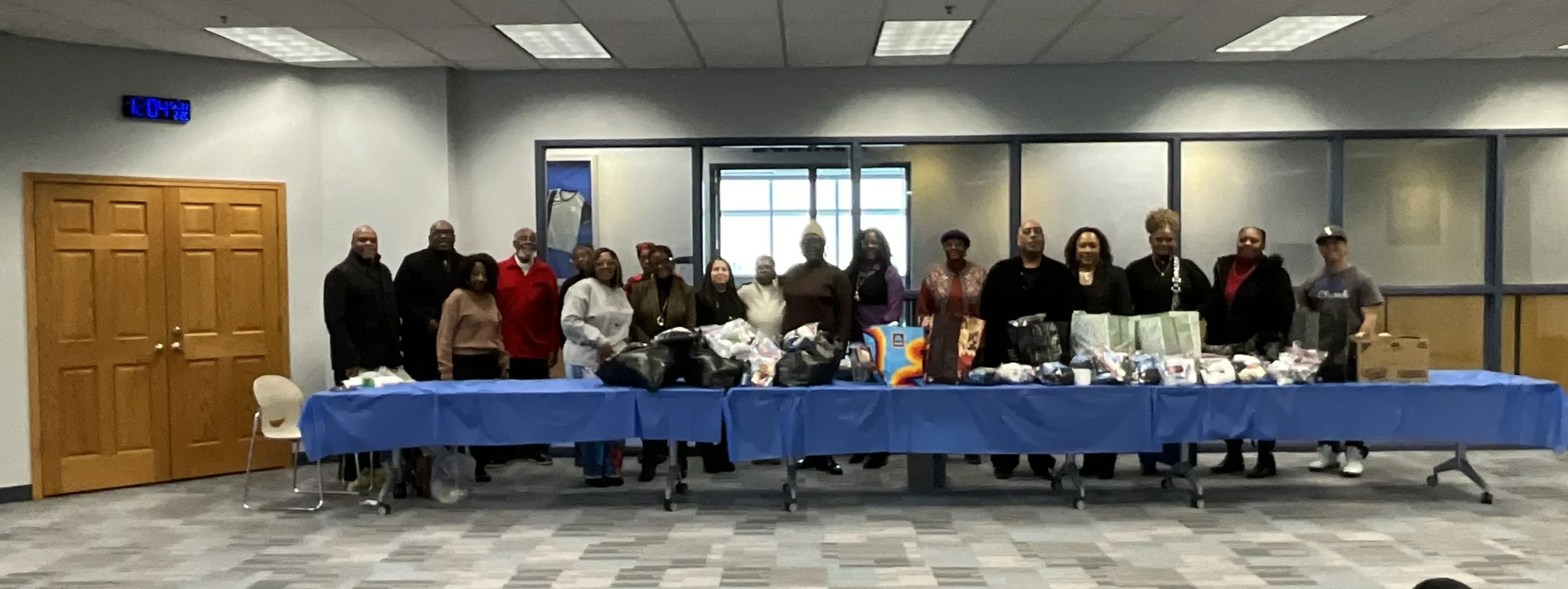 The Equippers Church Group in Romeoville stands behind a table with donations.