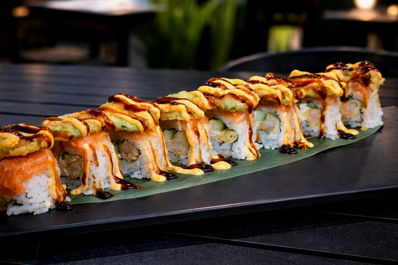 Nat Attack - $18.95
INSIDE: Shrimp Tempura, Cream Cheese, Cucumber
OUTSIDE: Spicy Salmon, Sliced Lemon, Fried Jalapeno, topped with Spicy Mayo, Eel Sauce, and Spicy Ponzu Sauce