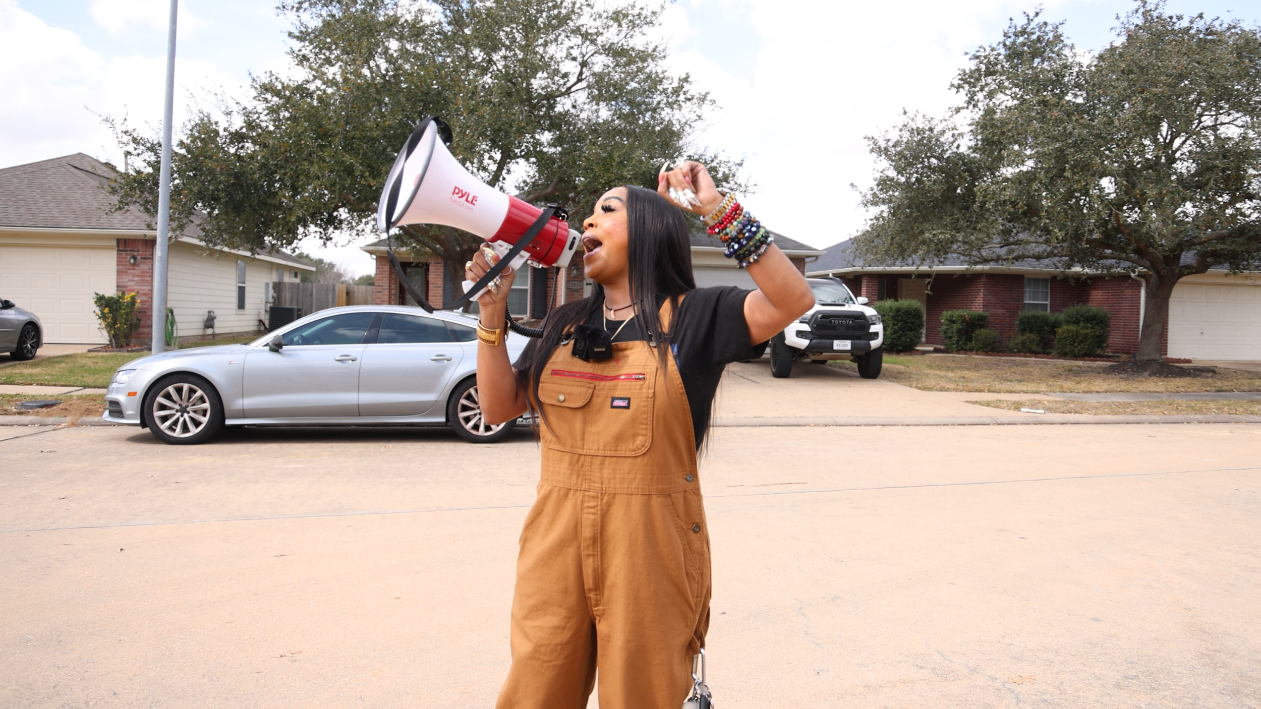 Dr. Matthews Leads Protest Outside Home of QX Global Facebook Page Operators