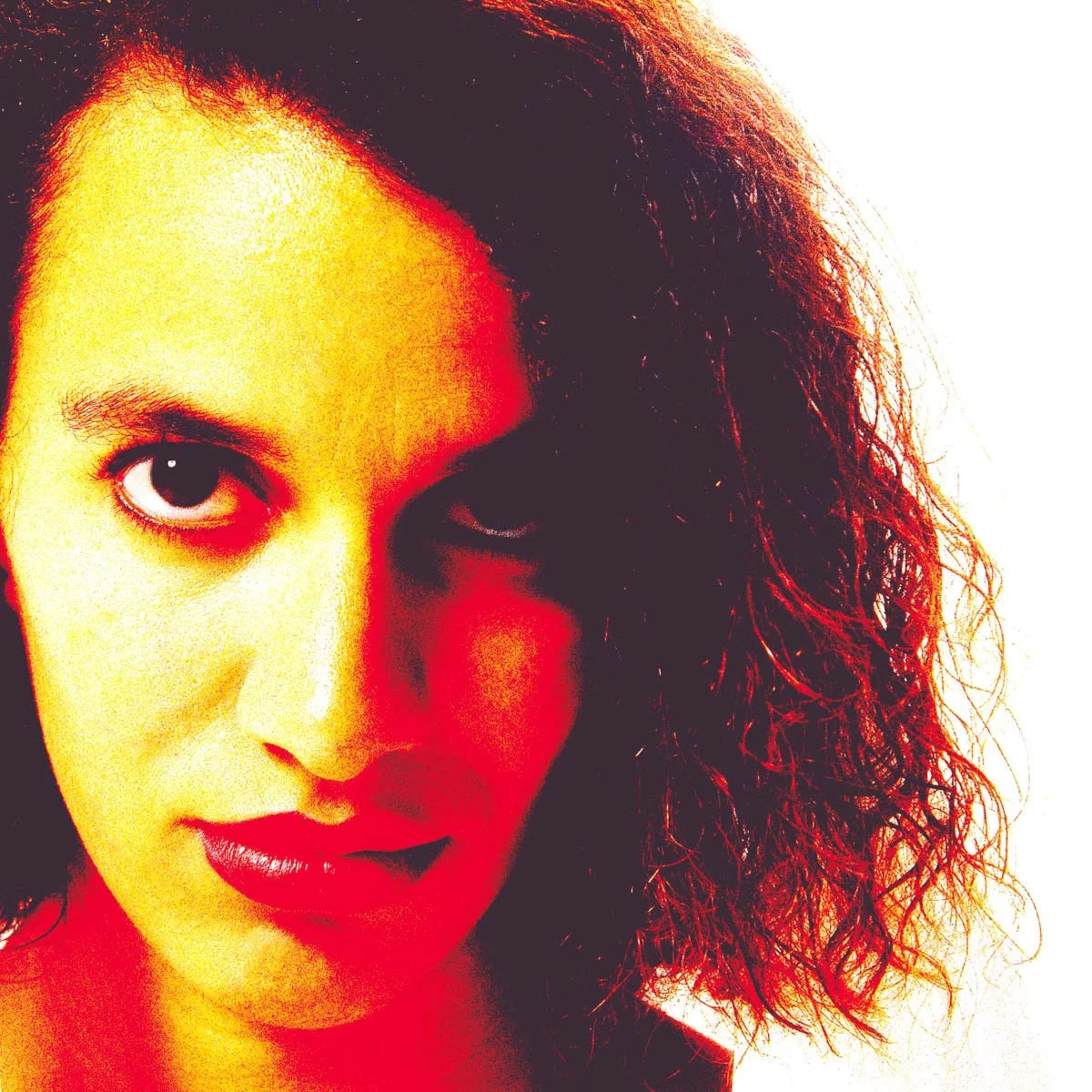 Creative close-up portrait of a woman using cross processing to obtain bold red and yellow color treatment.
