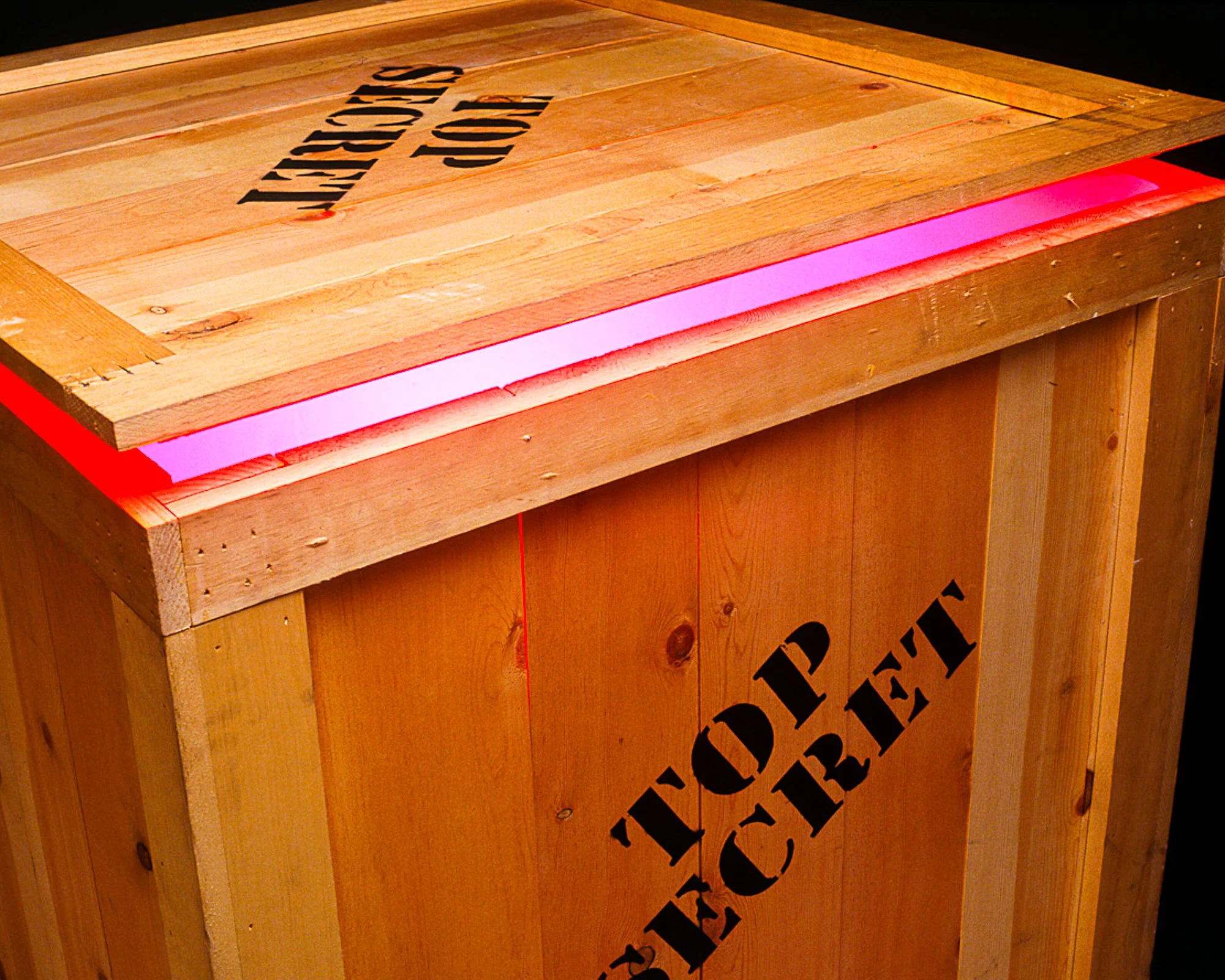 Wooden shipping crate or product container photographed with Top Secret markings.
