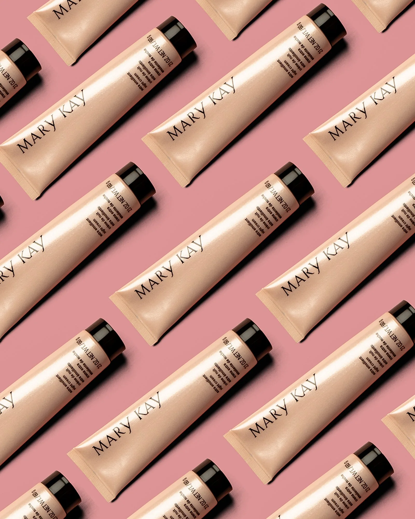 Cosmetics arranged in a repeating studio pattern.