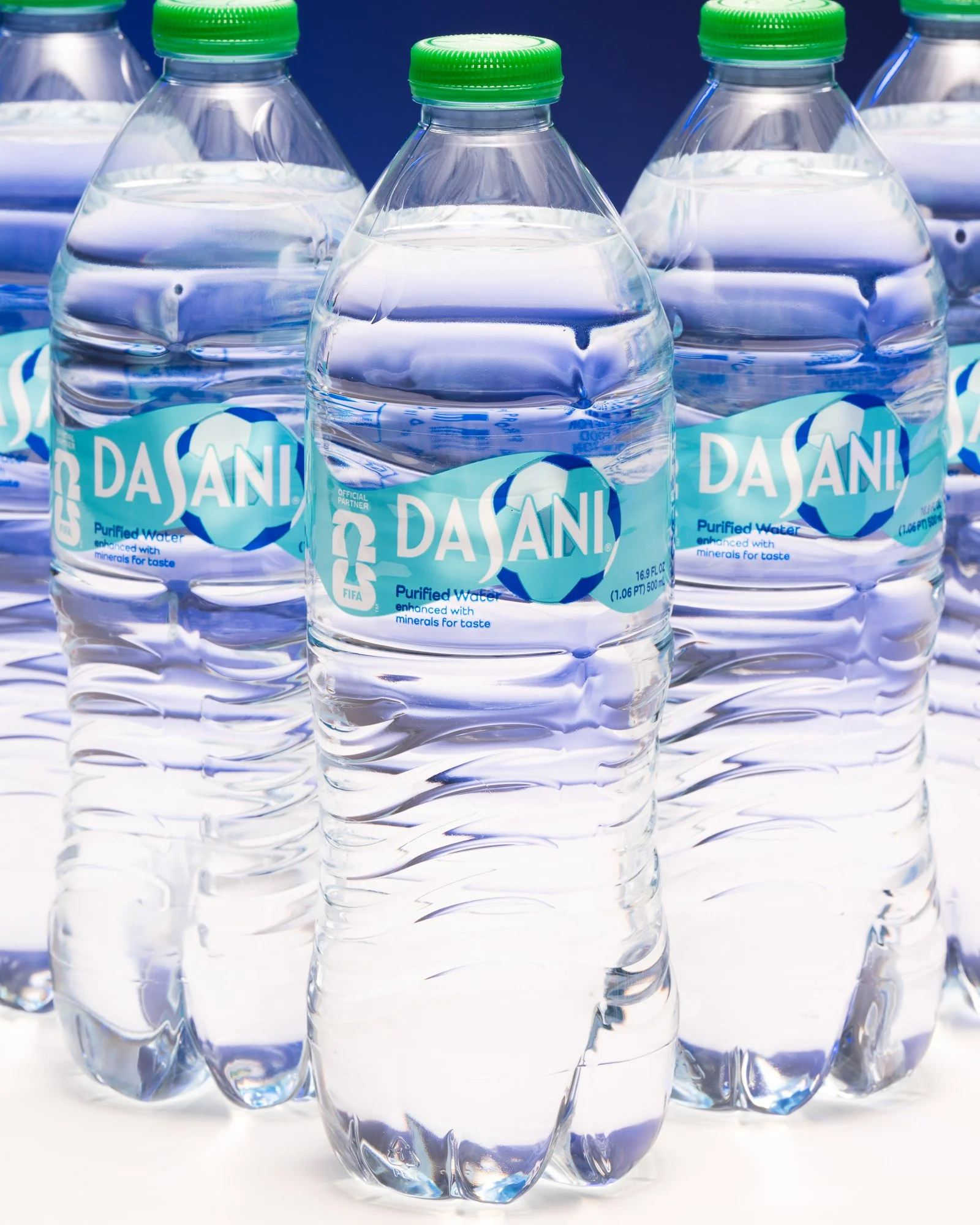 Dasani bottled water arranged as a commercial packaged-product display.