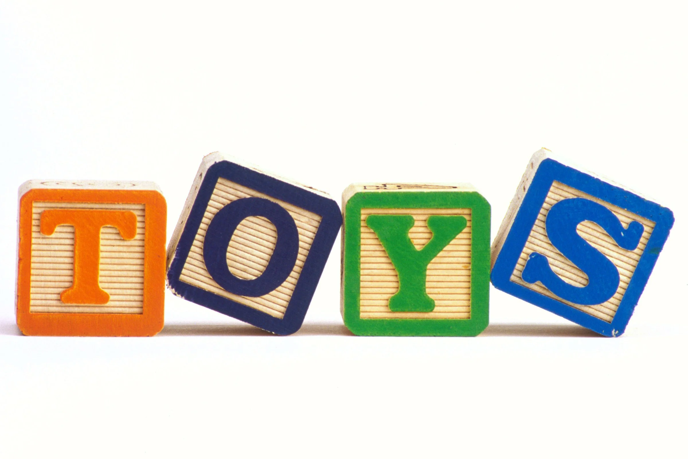 Colorful children’s learning blocks photographed against a bright background.