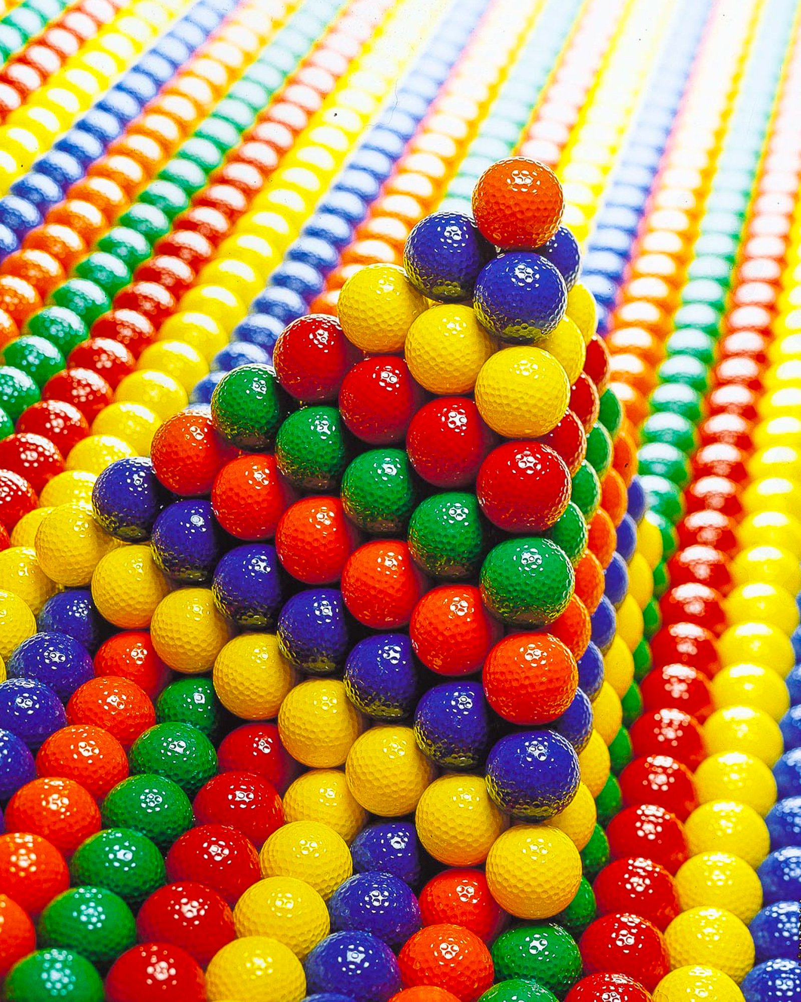 Colorful golf balls arranged in a geometric pattern for a bright product image.