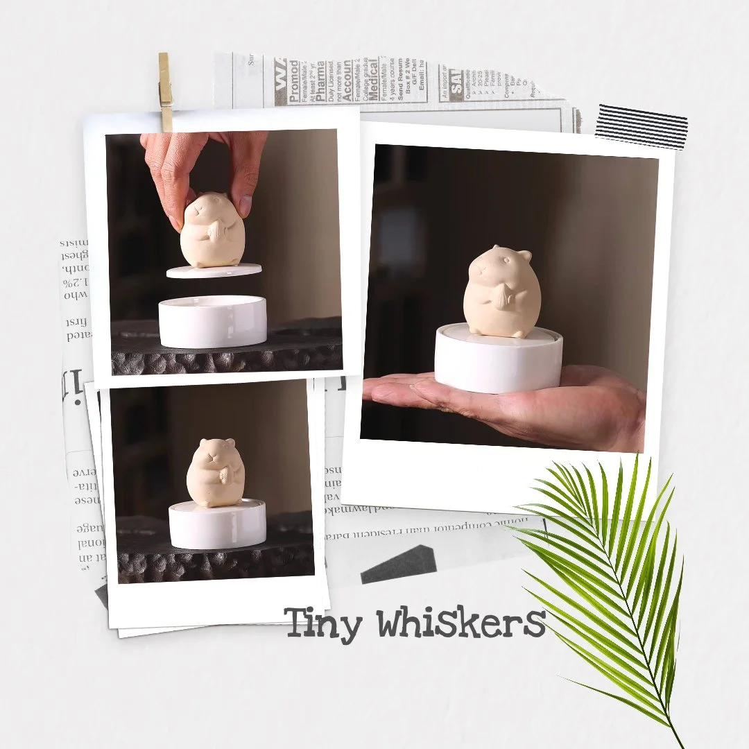 A collage of three photos showing a small, beige, hamster-shaped figurine on a white circular base, with a hand holding it in one photo. The collage is placed on a background of newspapers, with a green palm leaf and the text "Tiny Whiskers" at the b