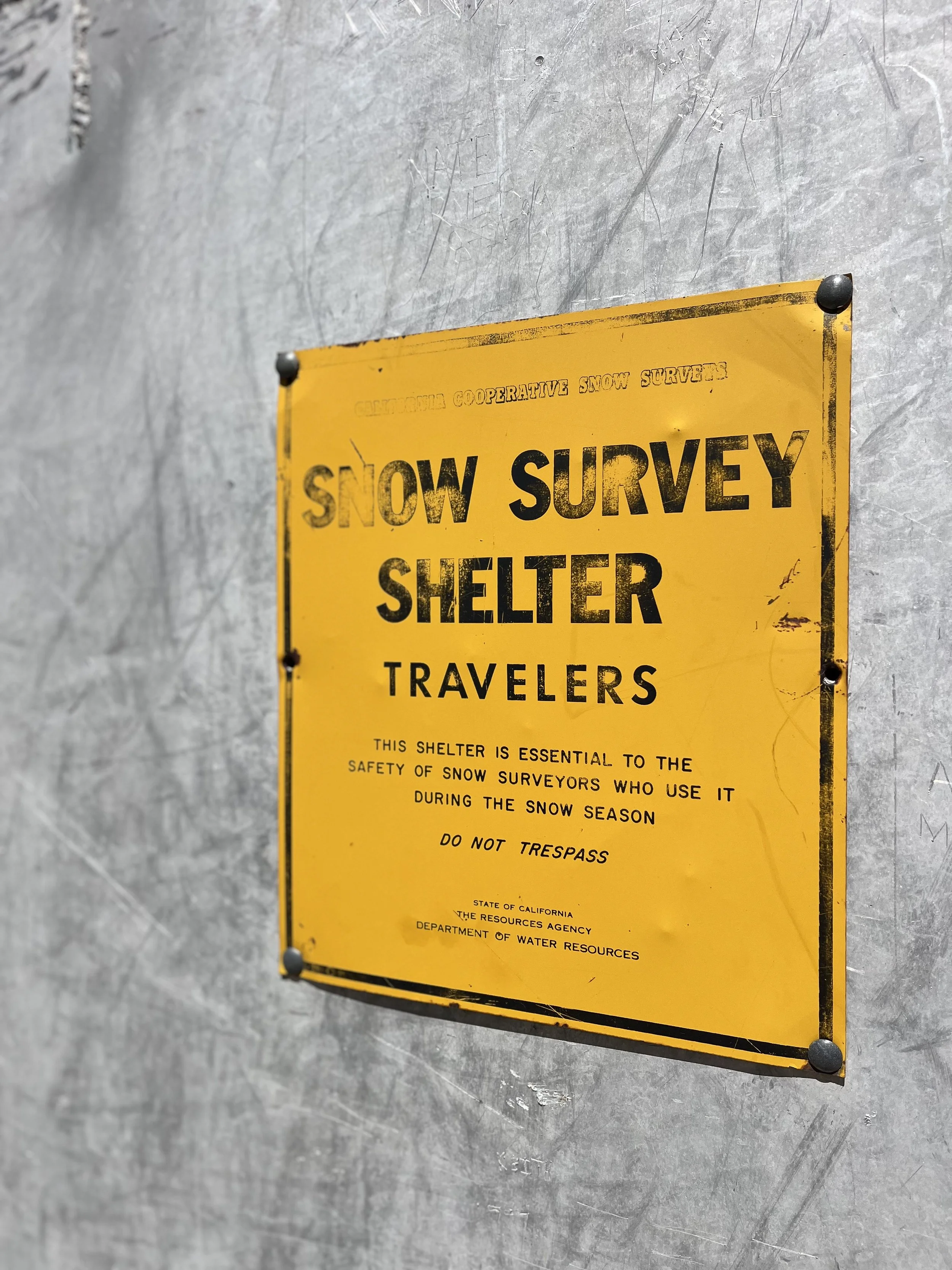 Signage on snow survey shelter.
