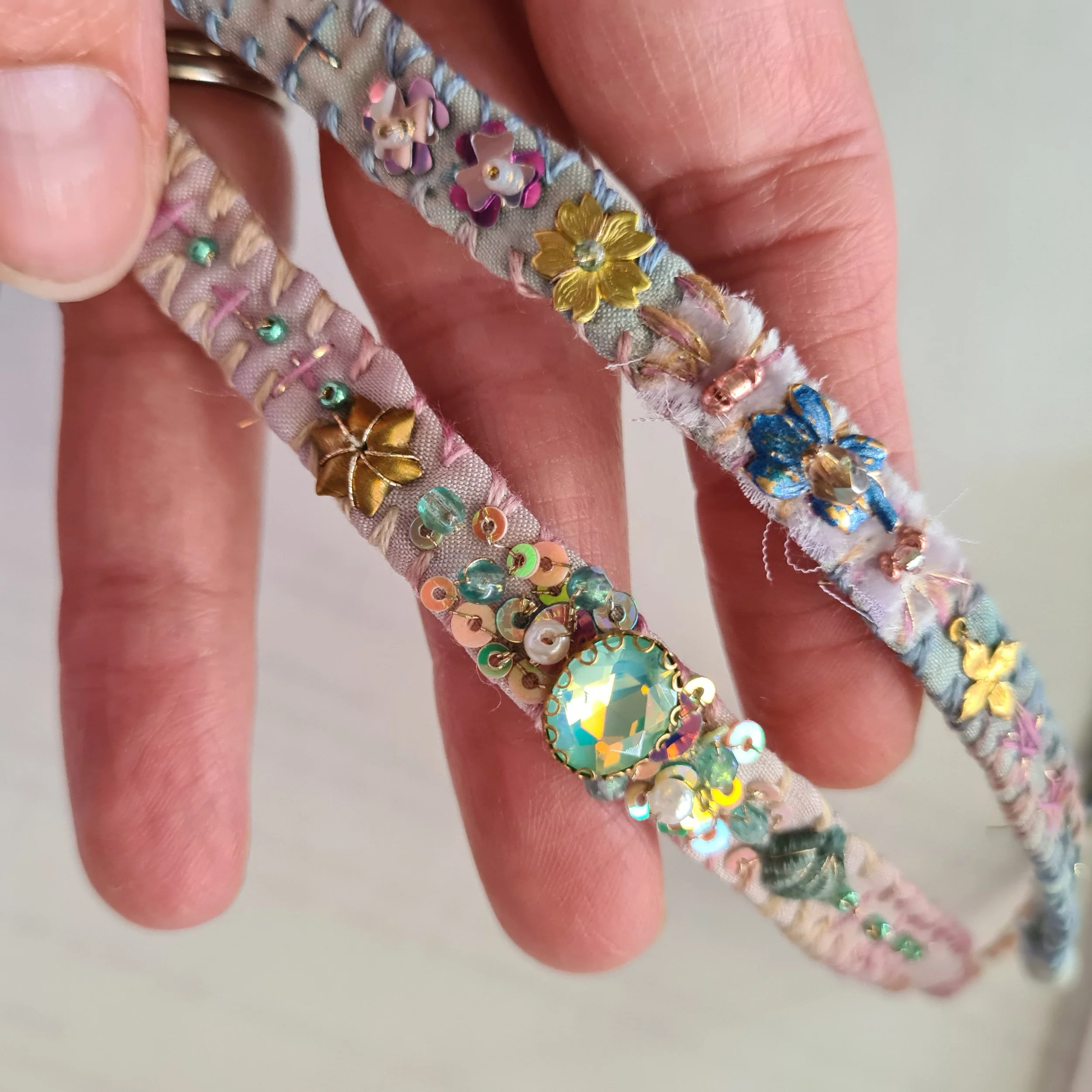 Two embroidered silk bracelets in pale pink