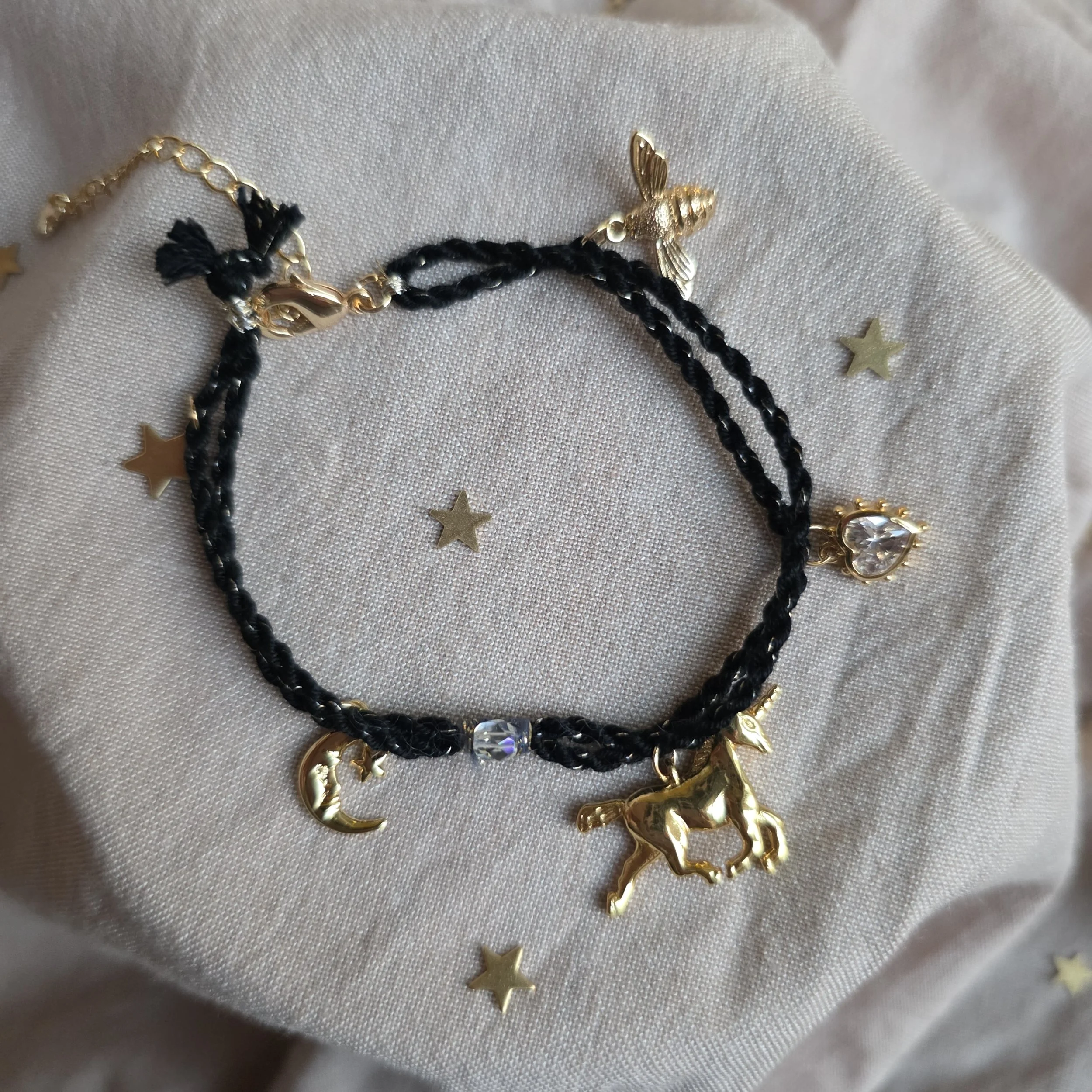 Twisted cord charm bracelet (black with gold tone charms)