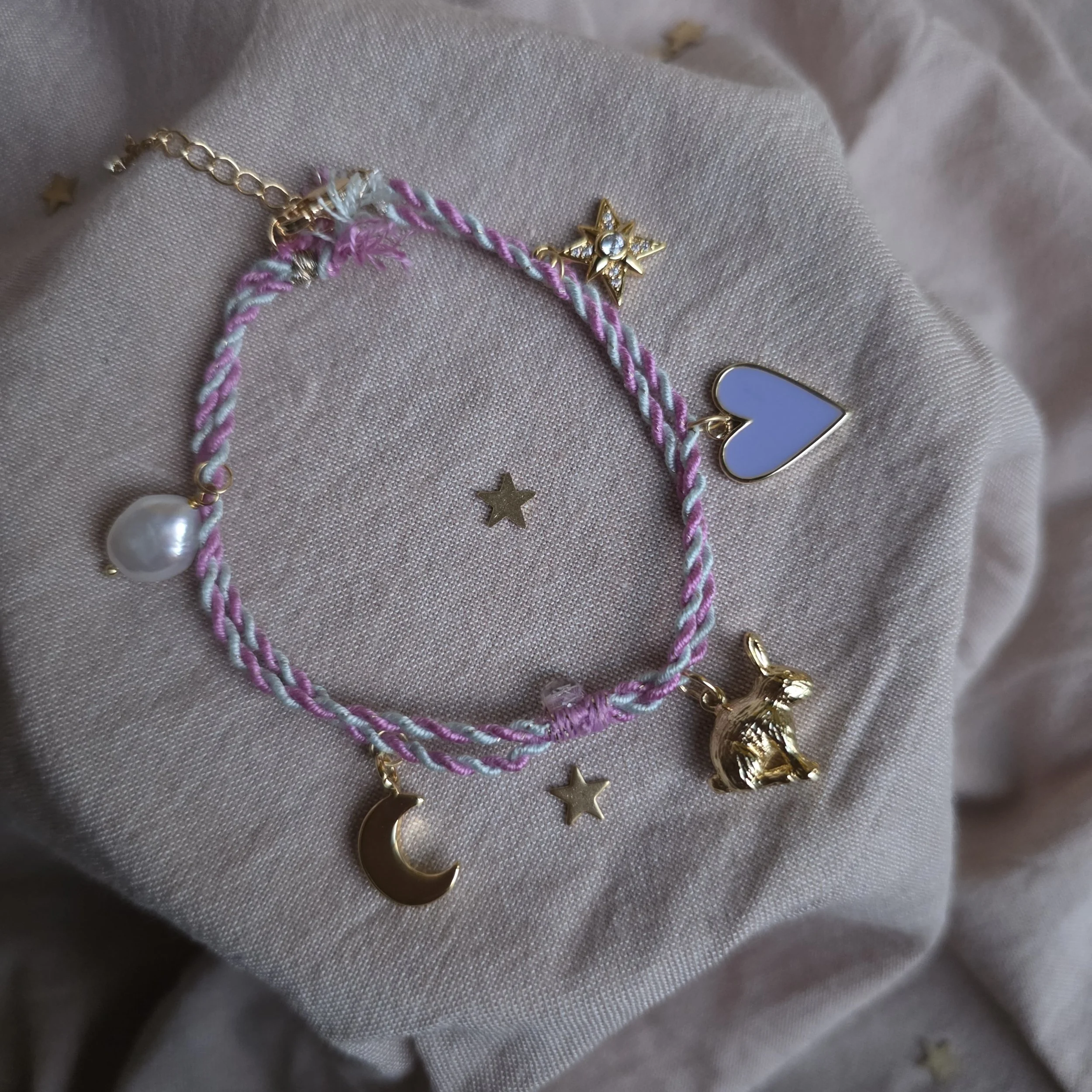 Twisted cord charm bracelet (pink and blue with gold tone charms)