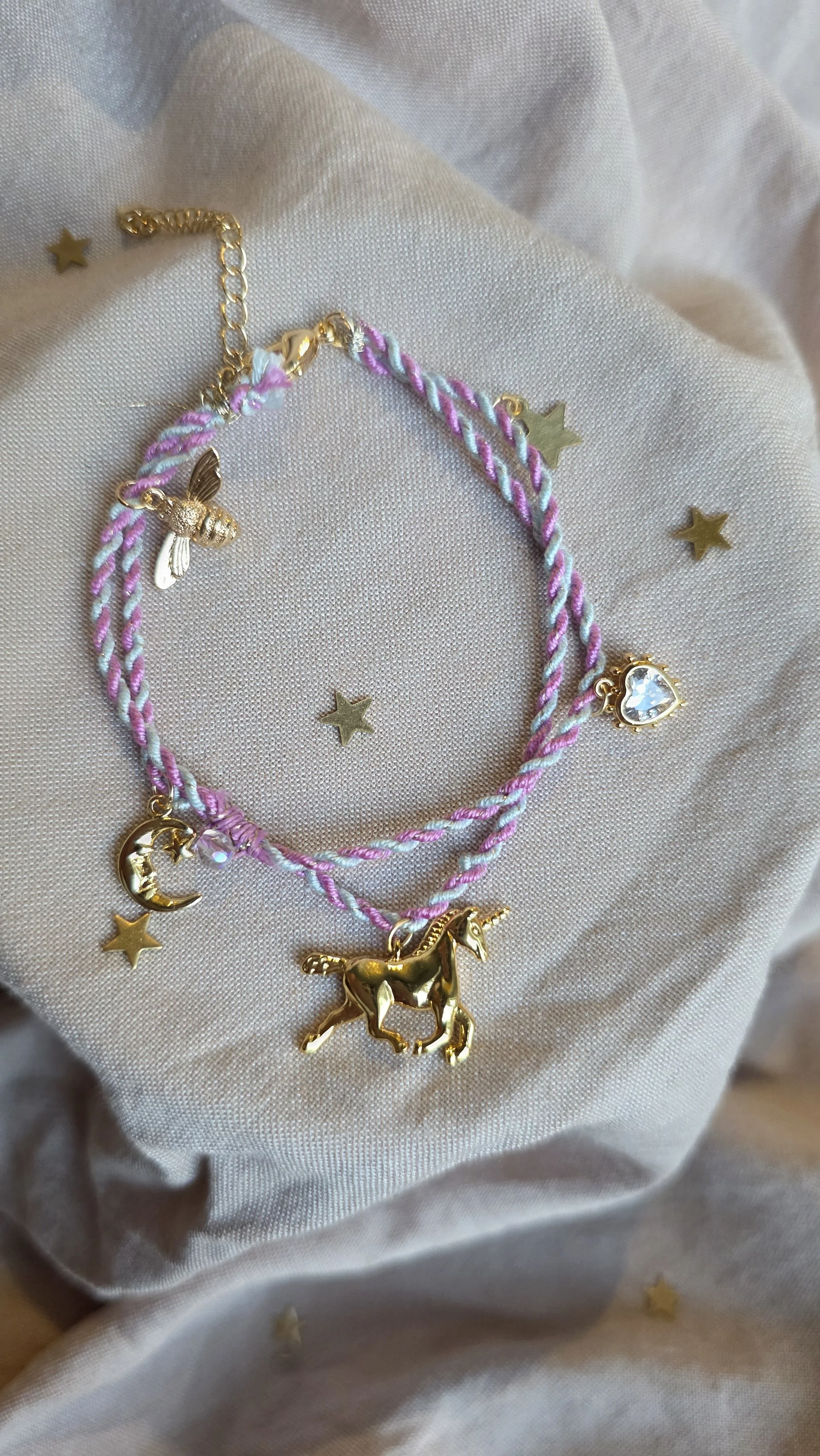 Twisted cord charm bracelet (pink and blue with gold tone charms)
