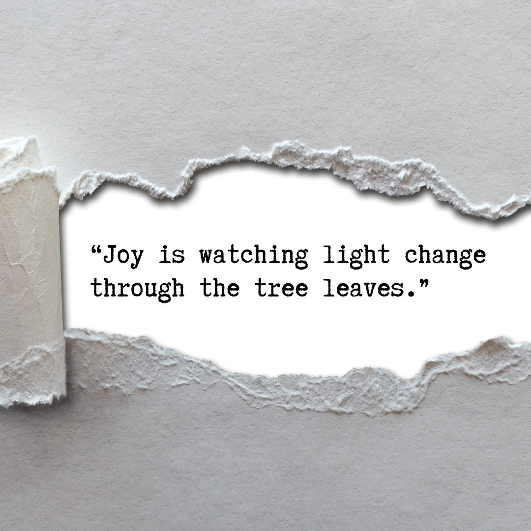 A close-up of a paper wall with a large tear revealing the black space behind it.