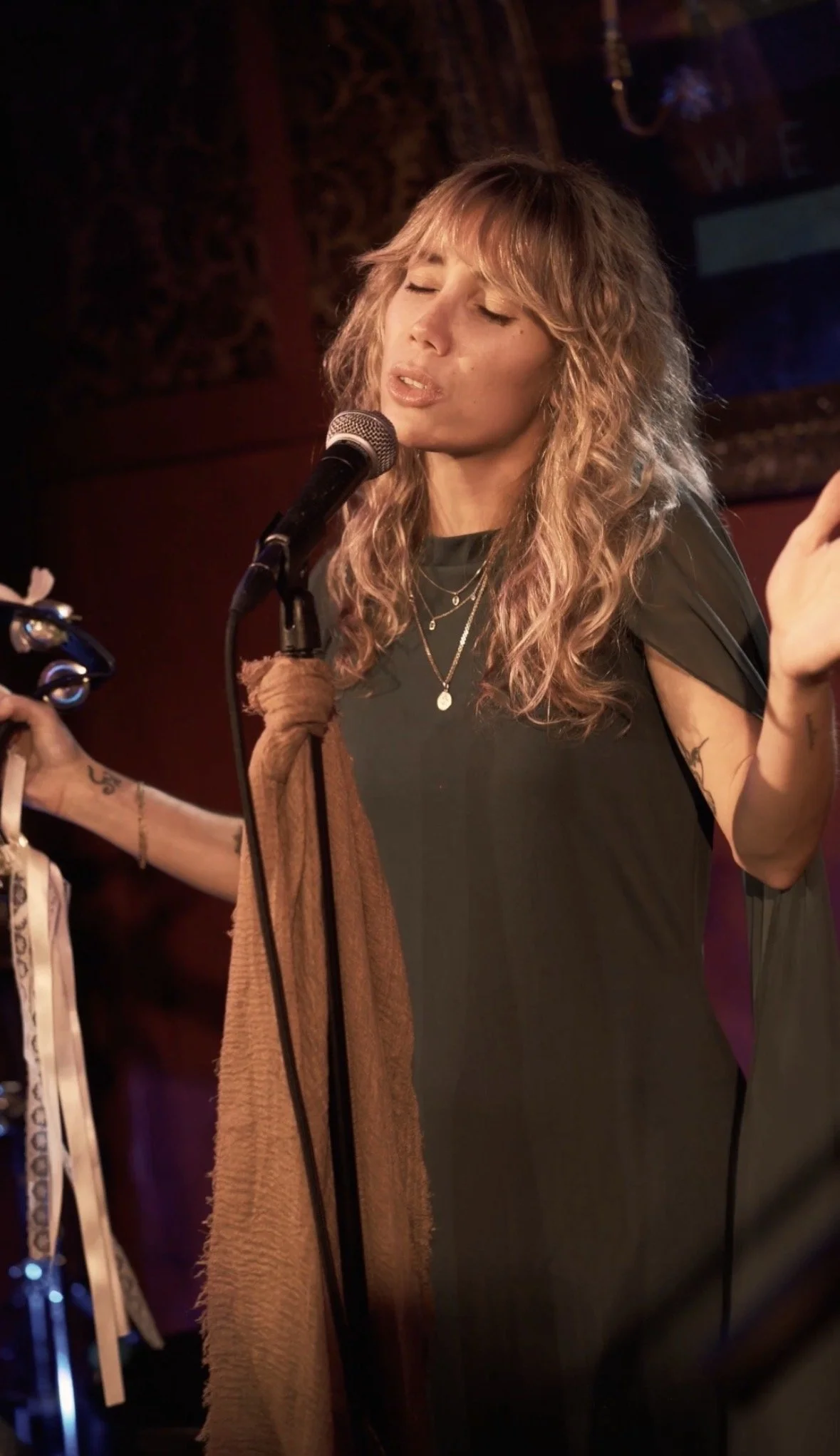 Kristen of Bel Mercy performing live vocals during an acoustic performance.