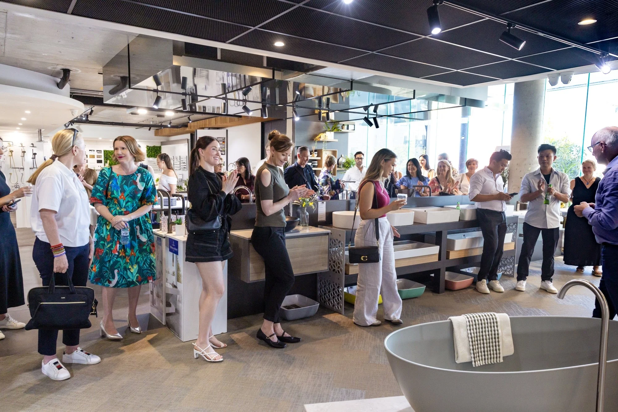 People shopping for kitchen and bathroom fixtures at a store.