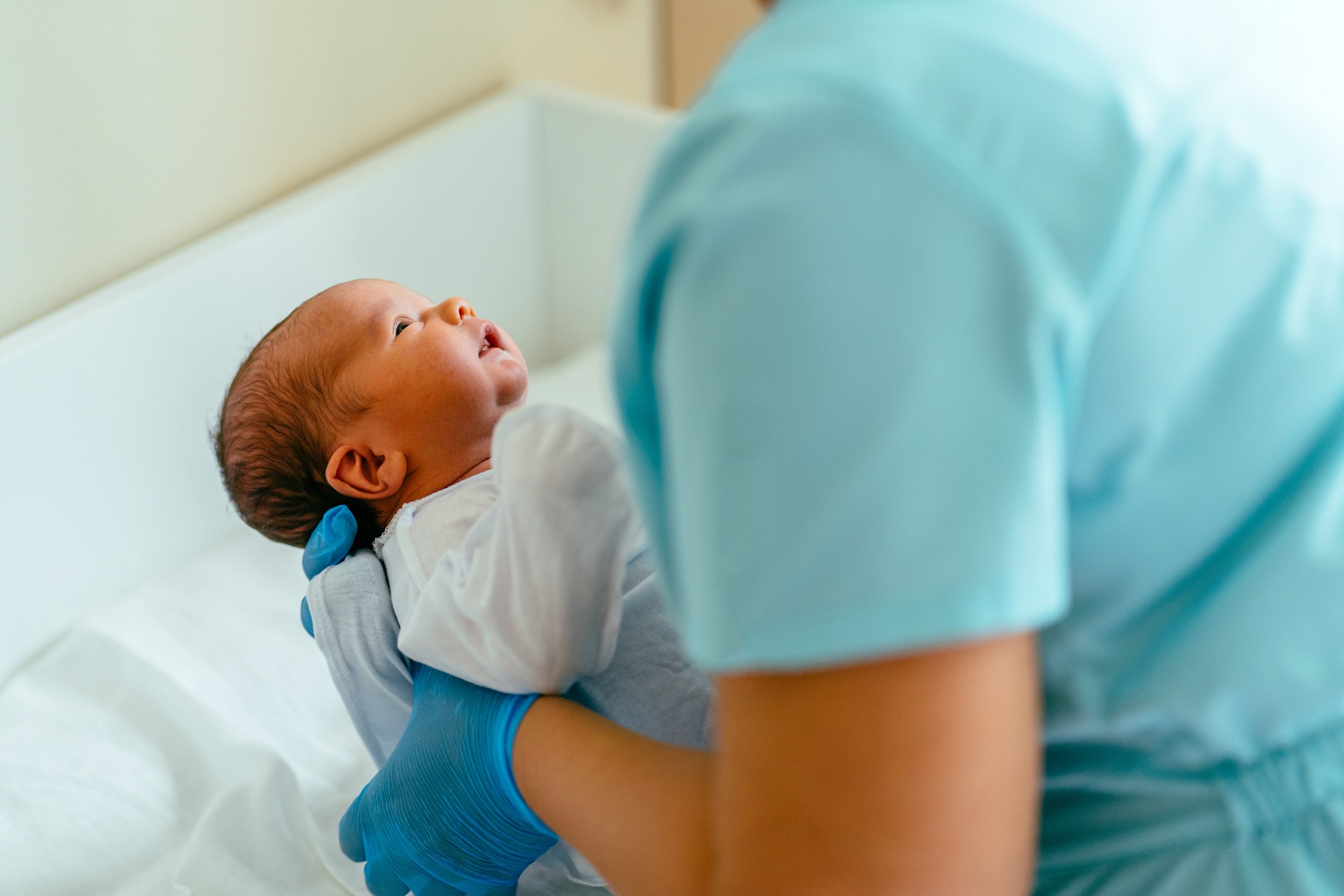 Newborn baby in a crib, cared for by a night nurse in Chicago