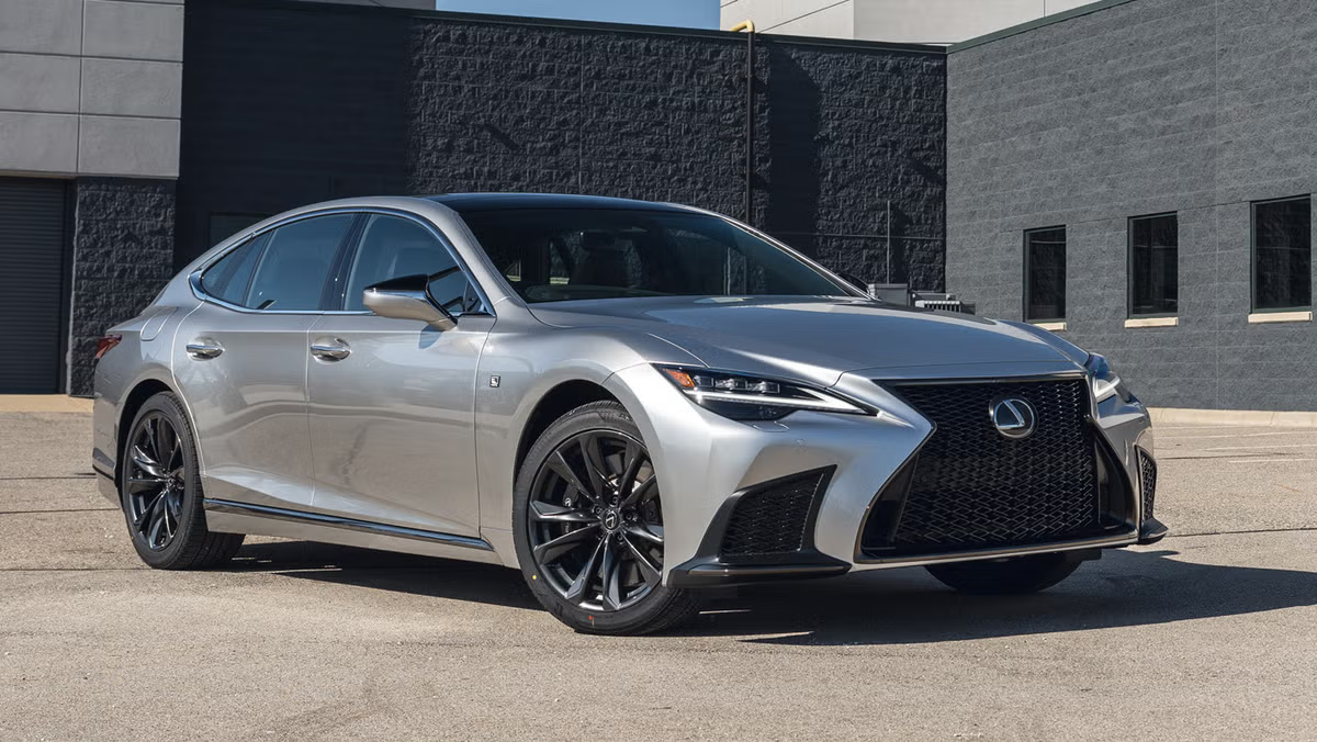 Silver Lexus sedan parked outside a modern building.