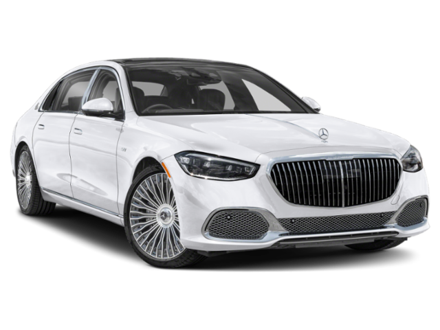 A white Mercedes-Benz luxury sedan with a sleek front grille and modern headlights.
