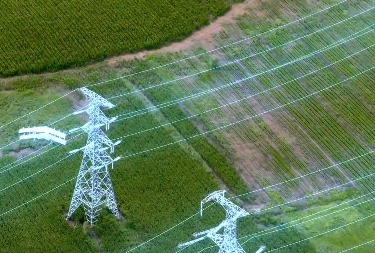 Fixed-wing VTOL UAV performing industrial drone inspection over a power line corridor