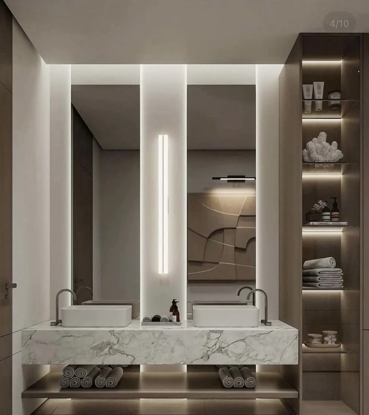 Bathroom with double sinks on a marble countertop and illuminated shelving