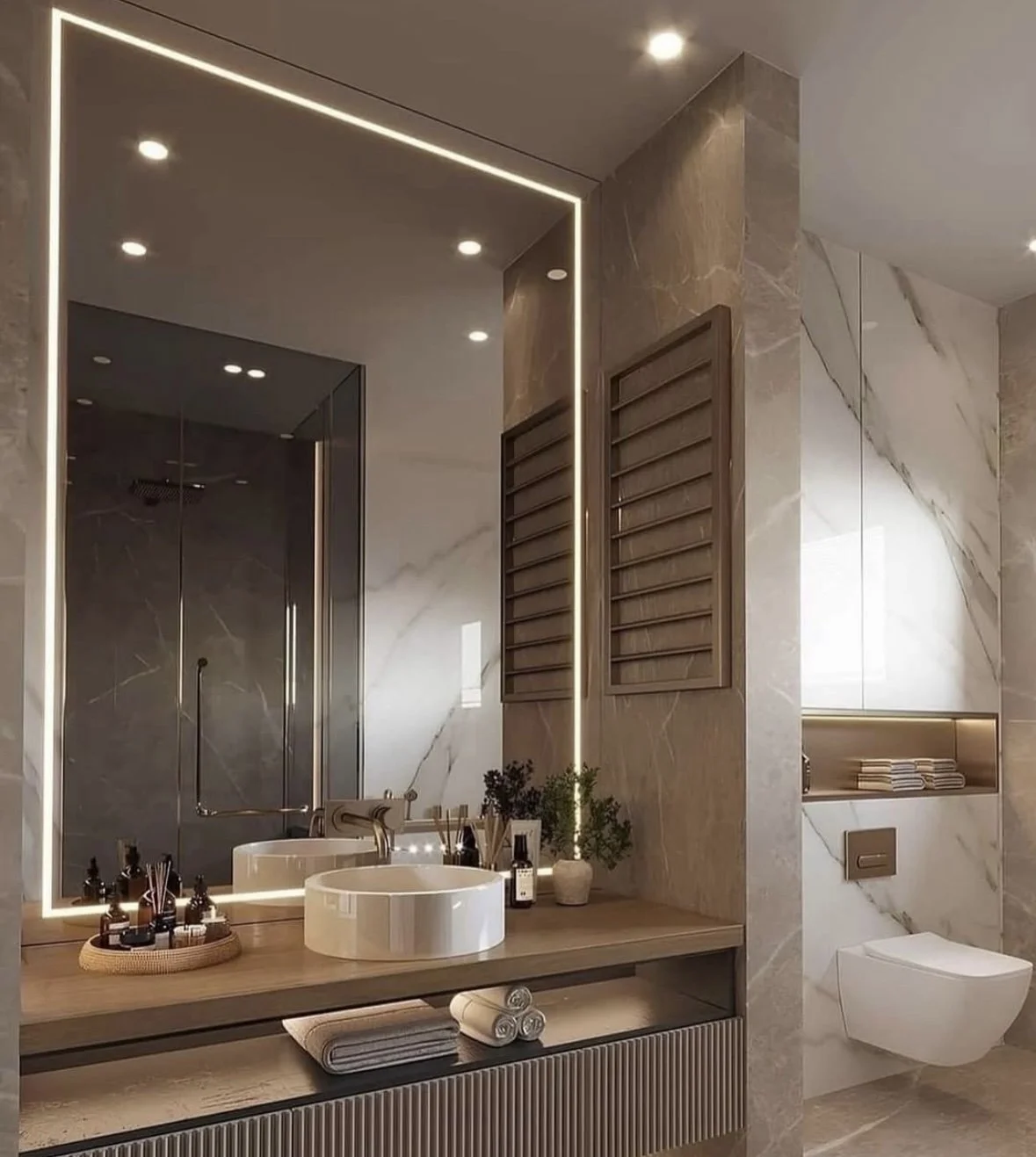 Bathroom with a large backlit mirror, a vessel sink and a wood countertop