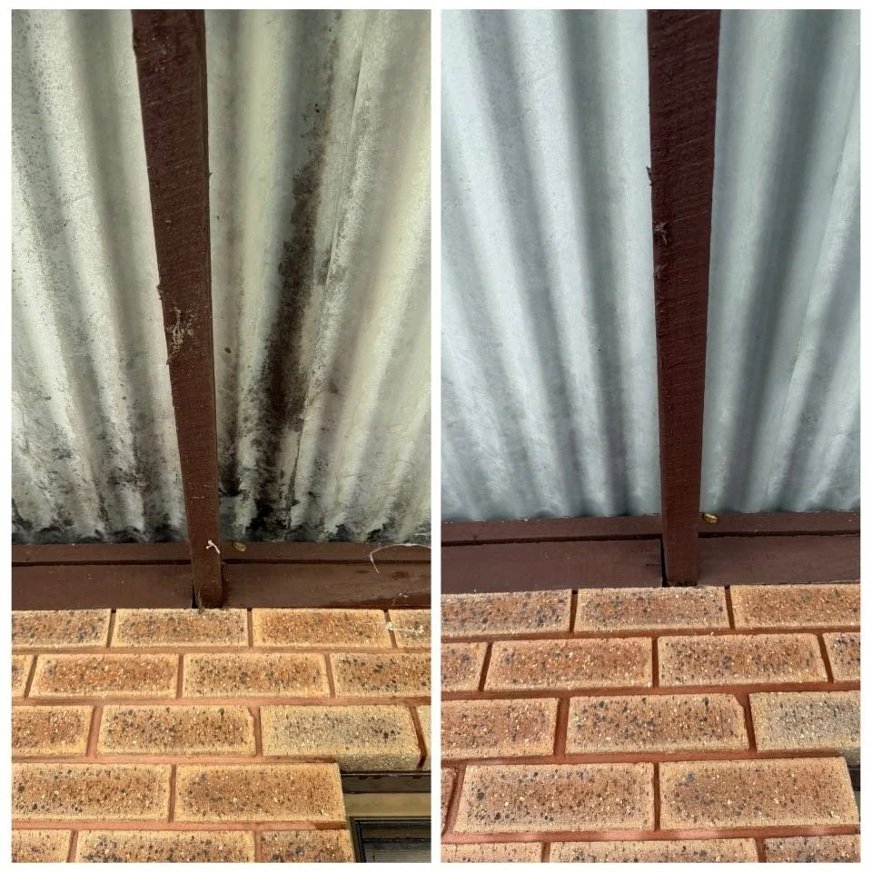 Side-by-side comparison of the underside of a metal roof, showing before and after cleaning. The left side has dirt and mold stains, while the right side appears clean and free of stains. A brick wall is at the bottom of both images.